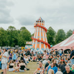 Helter skelter surrounded by a crowd of festival goers 