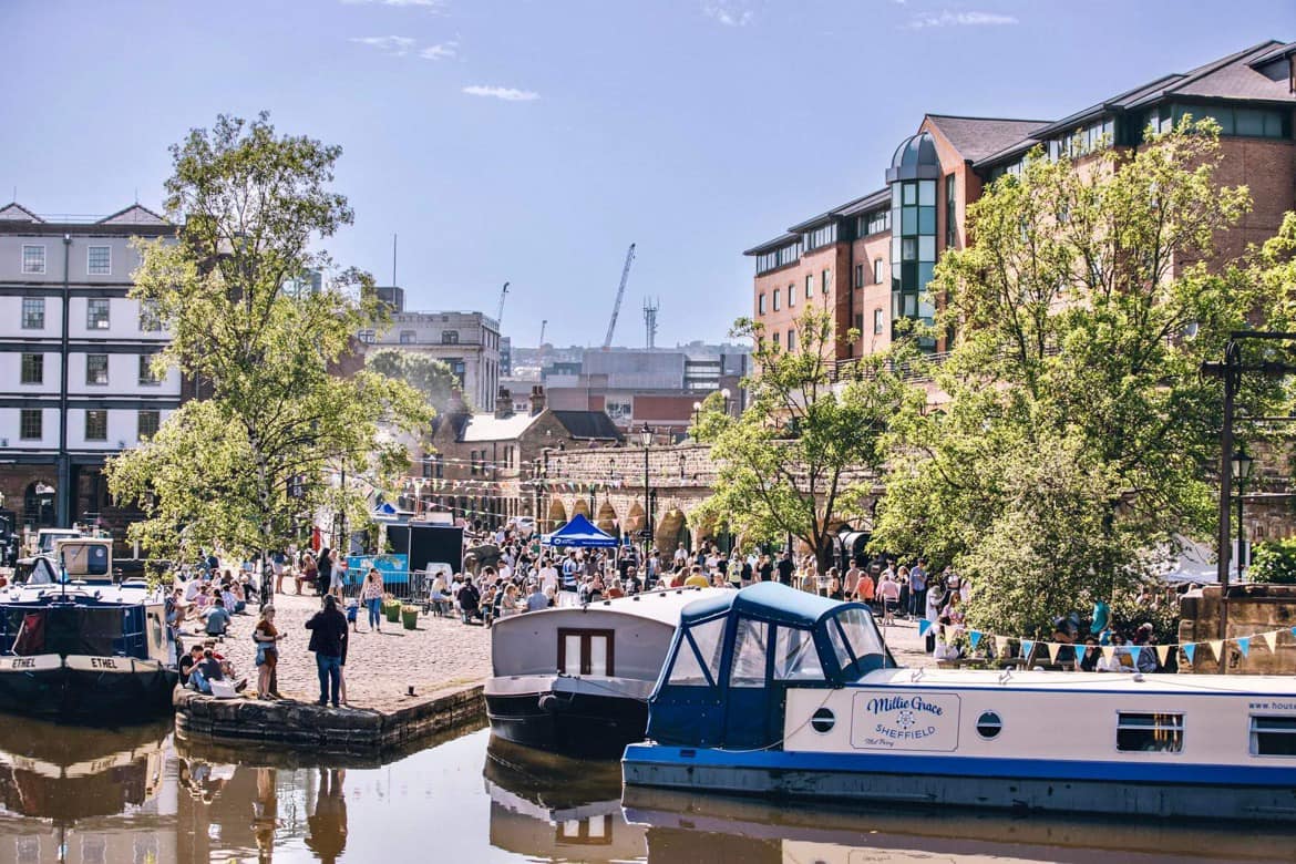 View of house boats in front of the quayside on market day 