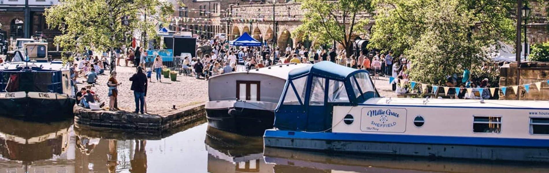 View of house boats in front of the quayside on market day