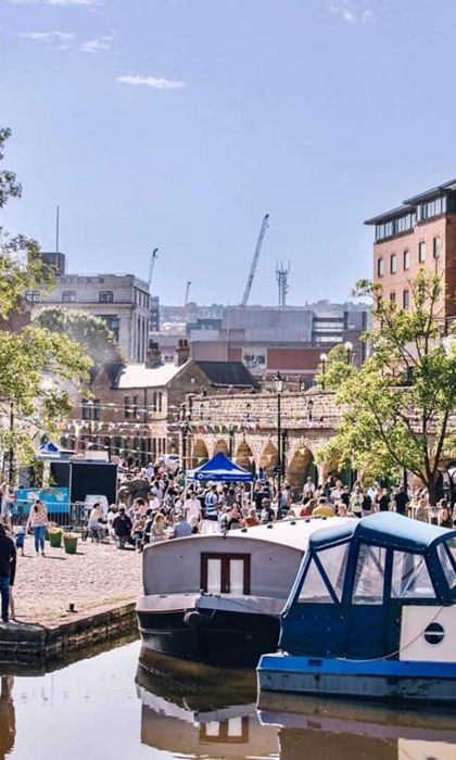 View of house boats in front of the quayside on market day