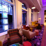 A waiting area at Curzon Sheffield, with armchairs and coffee tables.