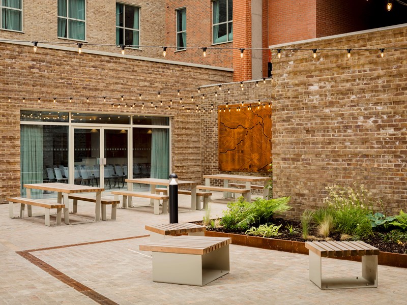 Outdoor area with benches and planted garden.