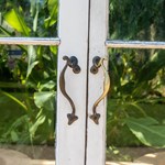 A close-up of one set of doors in the Glass House at Sheffield Botanical Gardens.