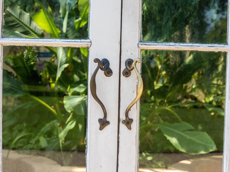 A close-up of one set of doors in the Glass House at Sheffield Botanical Gardens.