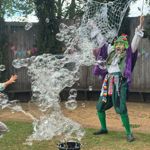 A person using a net on two sticks to create hundreds of bubbles at the Tropical Butterfly House Wildlife Conservation Park.