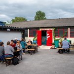 People enjoying a beer outdoors at The Brewery of St Mars of the Desert.