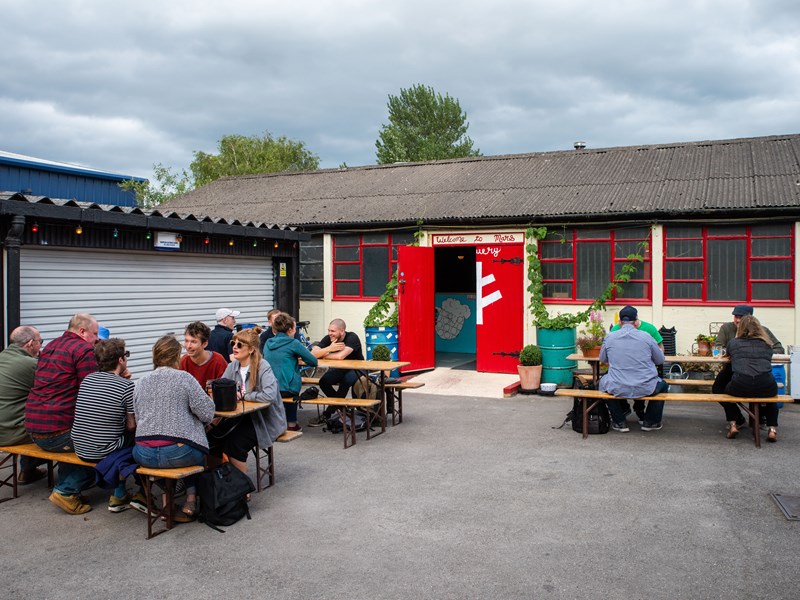People enjoying a beer outdoors at The Brewery of St Mars of the Desert.