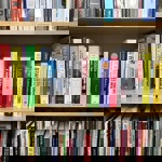 Shelves filled with neatly arranged new books at Next Chapter Books, featuring a range of colourful spines across genres including music, biography, literature, and non‑fiction.