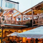 The courtyard at Hagglers Corner, filled with tables and chairs. You can also see the balcony that runs around the second floor.