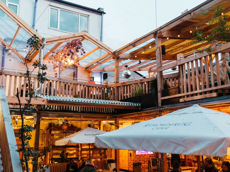 The courtyard at Hagglers Corner, filled with tables and chairs. You can also see the balcony that runs around the second floor.