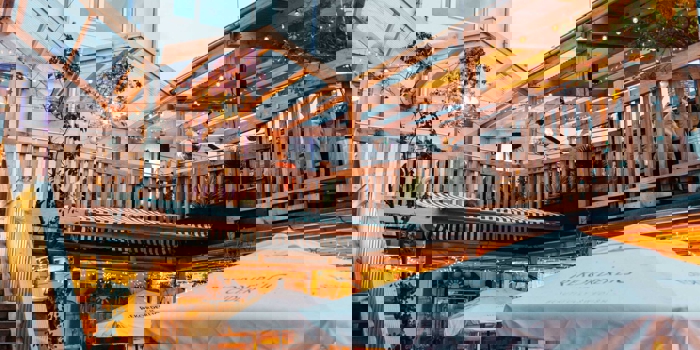 The courtyard at Hagglers Corner, filled with tables and chairs. You can also see the balcony that runs around the second floor.