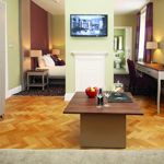 Bedroom with a comfortable living area featuring a sofa and coffee table.