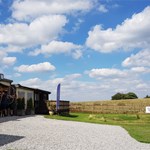A row of people practising archery.