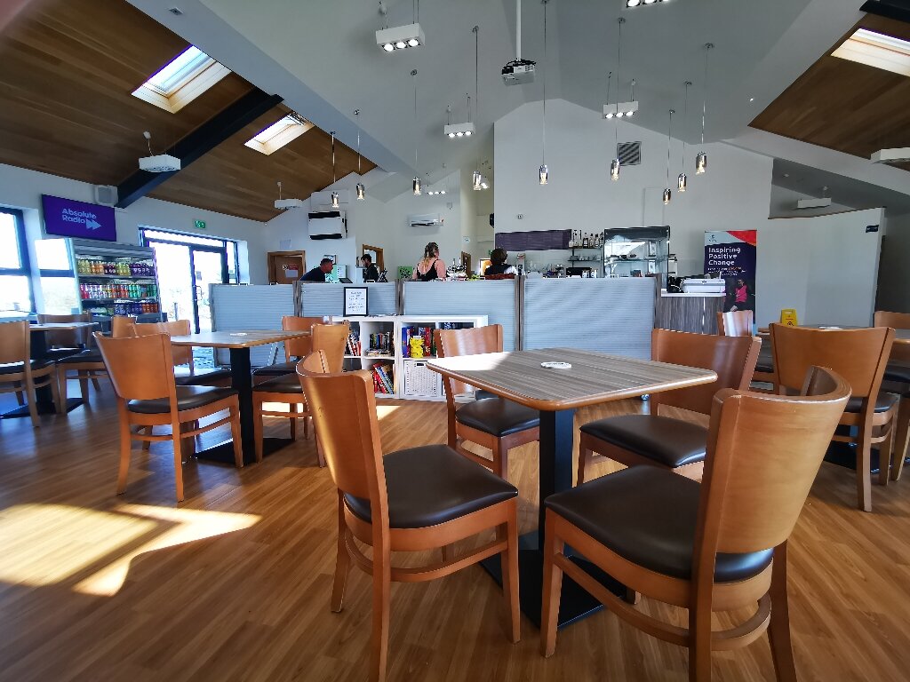 Café area at Waleswood Caravan and Camping Park with tables, chairs, and a welcoming atmosphere.