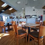 Café area at Waleswood Caravan and Camping Park with tables, chairs, and a welcoming atmosphere.