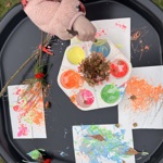 A close up of a small child painting.