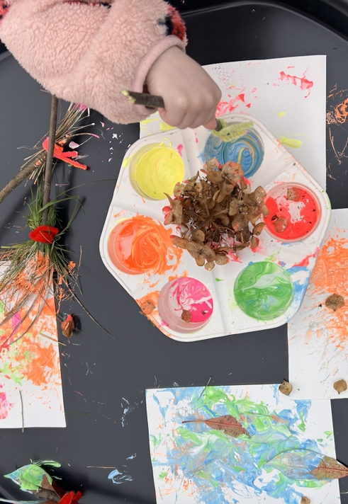 A close up of a small child painting.