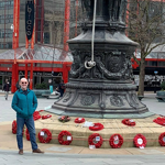 A man stands next to the War Memorial in Barkers Pool, Sheffield.