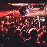 Disco ball above people dancing at Panke Social