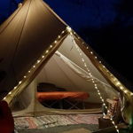 A tent lit up with a string of lights.