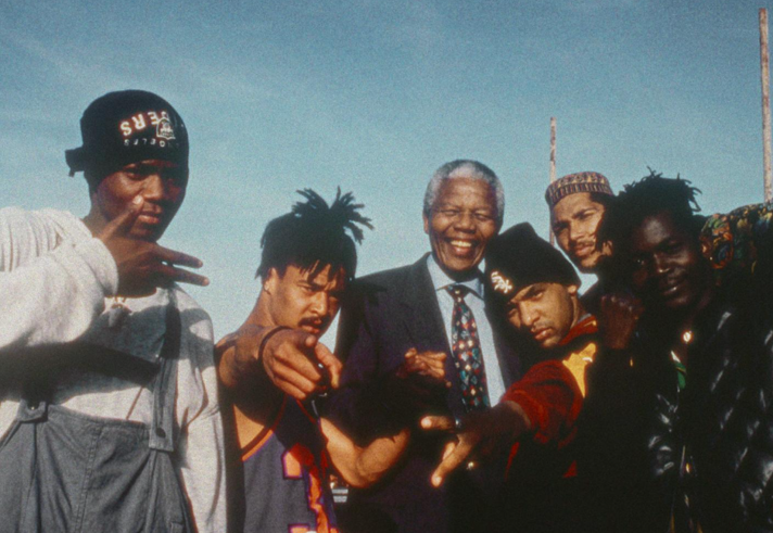 A group of young men posing in the street.