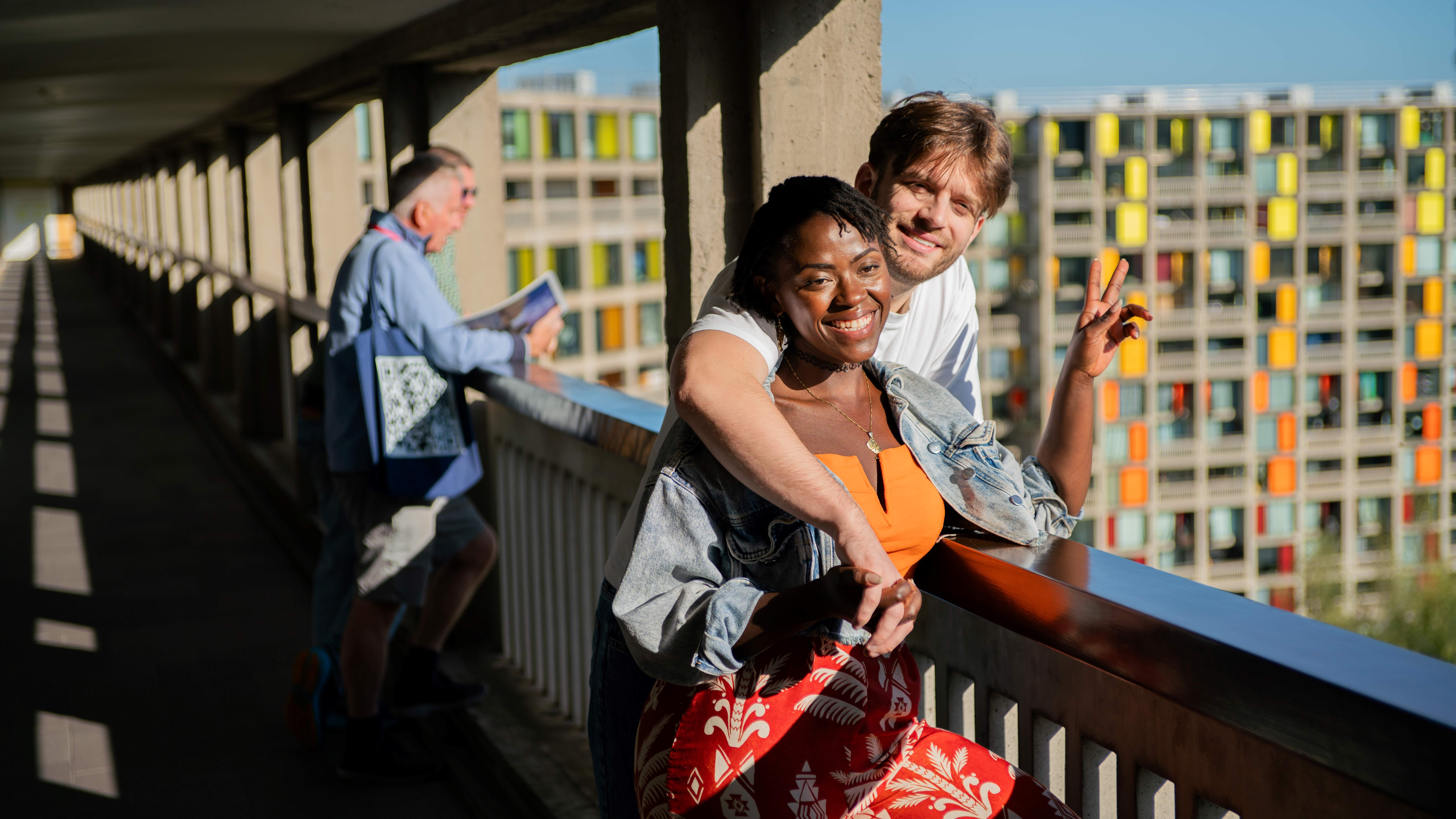Visitors take part in a guided tour at Park Hill in Sheffield, standing along an elevated walkway with views across the city.