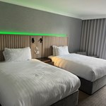 Modern bedroom with two single beds and ambient mood lighting