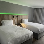 Modern bedroom with two single beds and ambient mood lighting