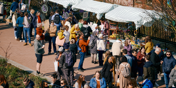 Crowds of people are looking at various stalls at Pollen Market in Sheffield.