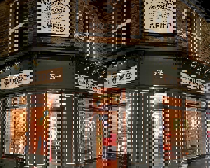 The exterior of the Two Sheds at night.