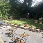 Outdoor garden of The Dalbury & Palmer Hotel featuring tables, chairs, and seating for guests.