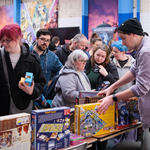 People looking through stalls piled high with all types of games at a previous Charity Game Swap.