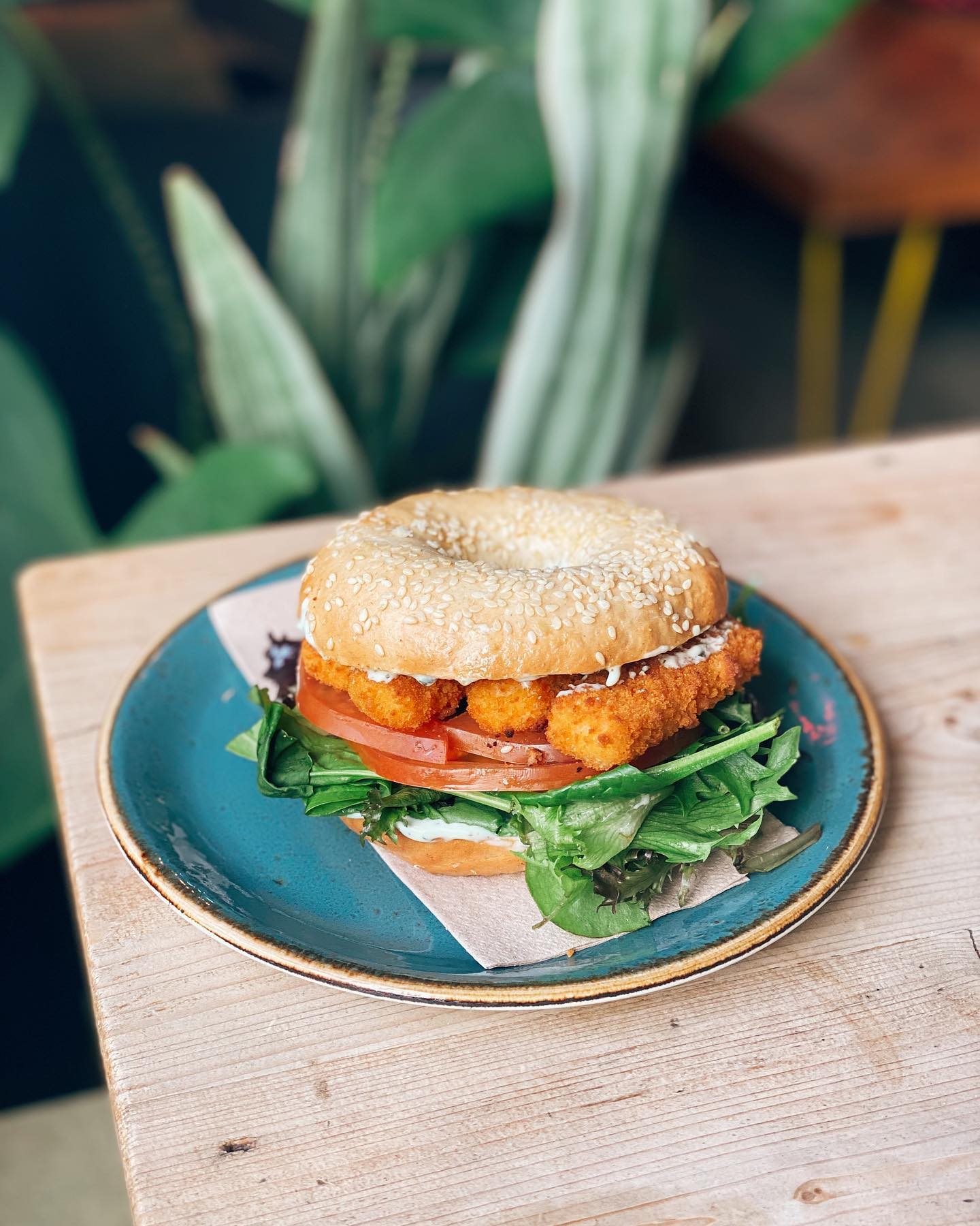 A fish-finger sandwich in a bagel.