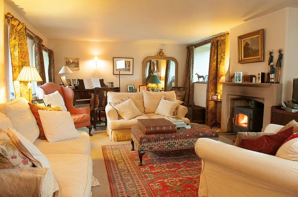 Loadbrook Cottage – living room with soft furnishings and a log burner.