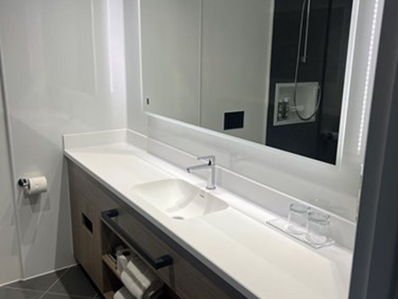 Bathroom with a sink and a mirror mounted above it.