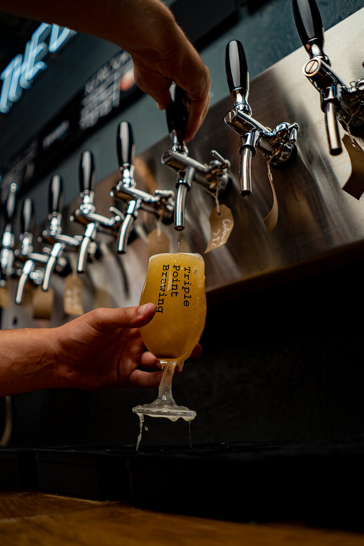 A beer being pulled at the Triple Point Brewery & Bar.
