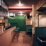 The interior of the bar Public, in Sheffield city centre, showing off the beautiful dark wood and green velvet interior. 