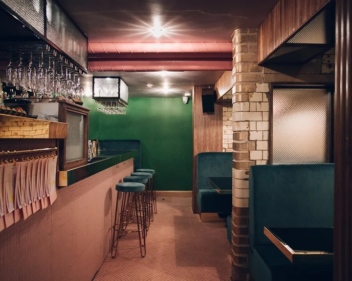The interior of the bar Public, in Sheffield city centre, showing off the beautiful dark wood and green velvet interior. 