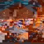 People eating at tables outside Saw Grinders Union at night.