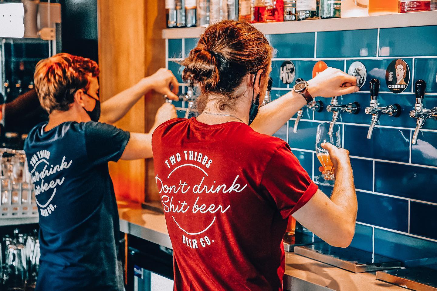 Two members of staff pulling pints at the Two Thirds Beer Co.