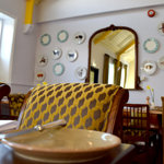 A close up of a table and upholstered chairs at The Cricket Inn.