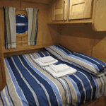 Houseboat Hotel – double bed area with stripy bedding