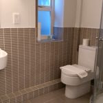 Homely Apartments – Figtree bathroom with walk-in shower, vanity, and modern fittings.