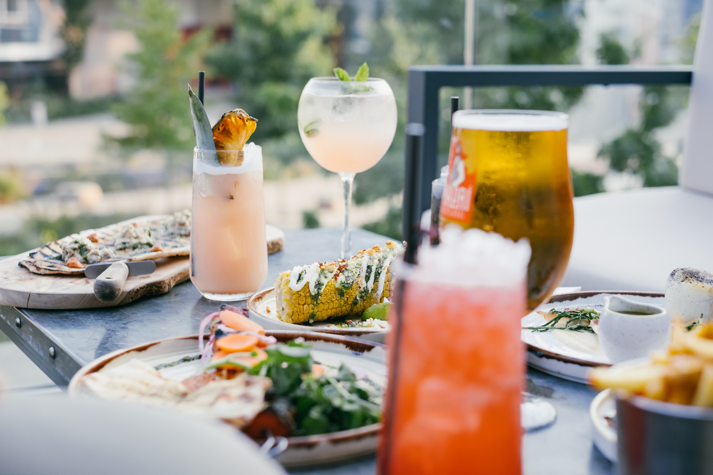 A table laid with a light lunch and cocktails.