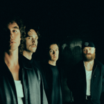 Promo shot of the band Don Broco looking moody and lurking in the shadows.