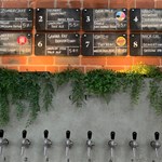 Beer pumps set into a wall behind the bar at Saw Grinders Union.