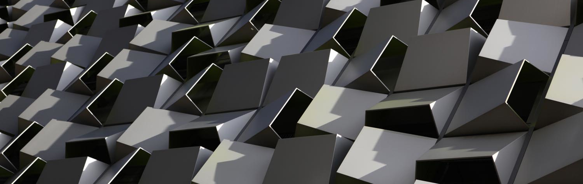 An artistic close up of the tessellated steel boxes that form the facade of a building in central Sheffield.   