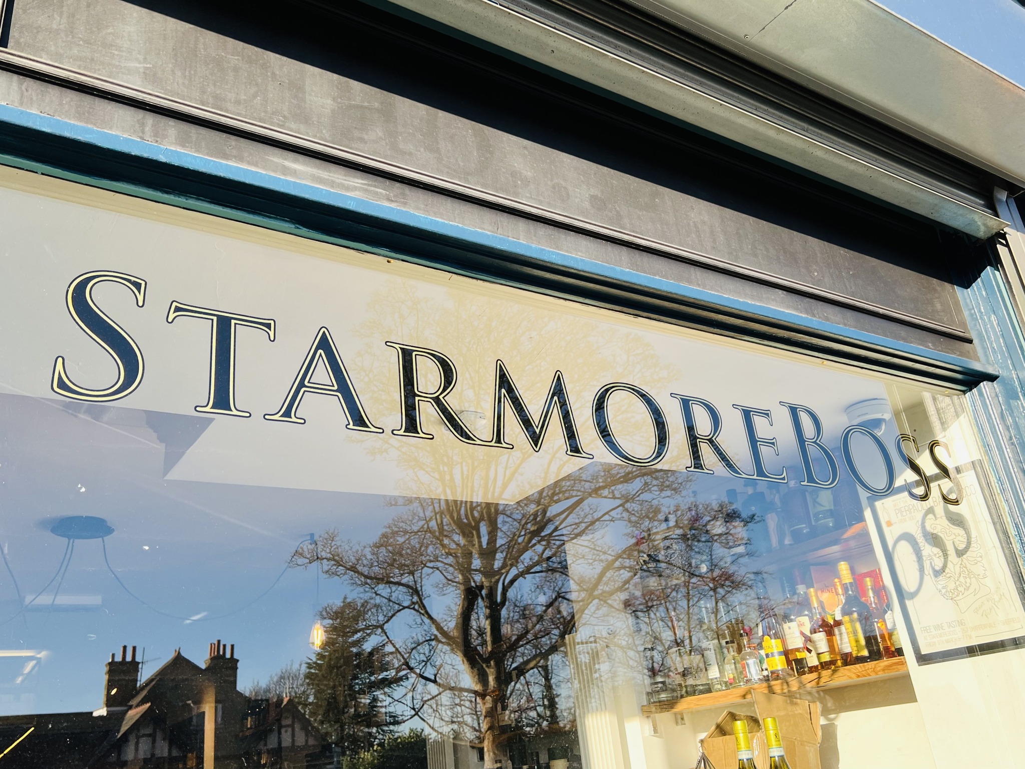 A windoe with Starmore Boss painted on it in gilded lettering.