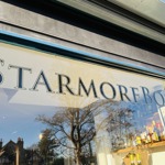 A windoe with Starmore Boss painted on it in gilded lettering.