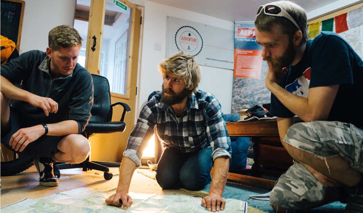 People gathered round looking at a map.